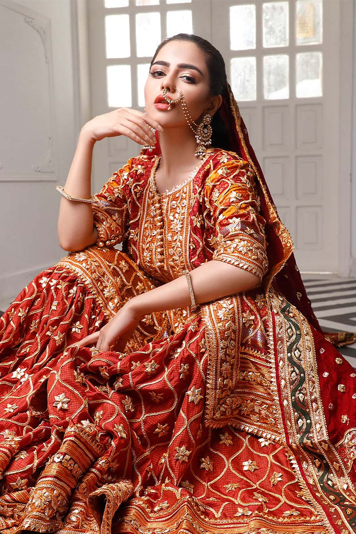 Mustard & red short shirt gharara set with gota-detailed dupatta.